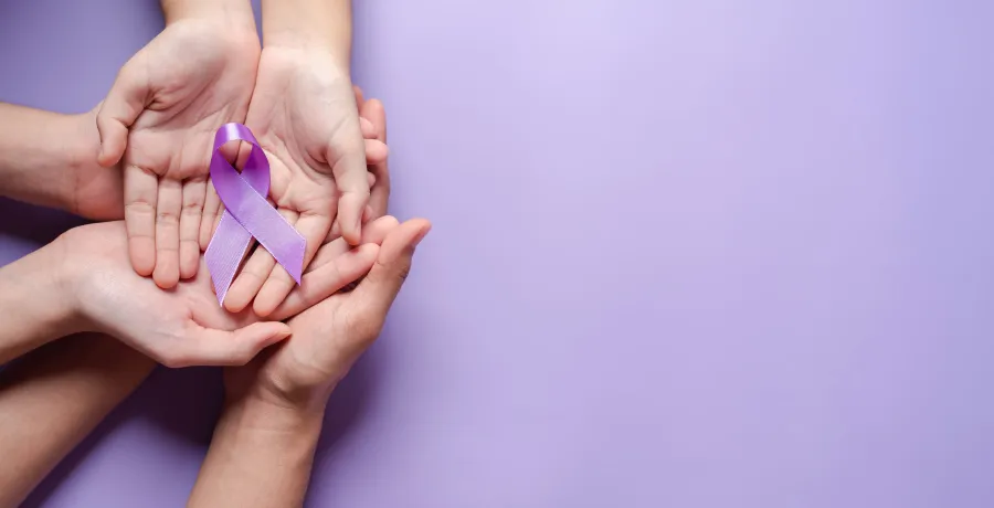 Family-violence.jpeg Overlapping hands on purple background and purple ribbon.