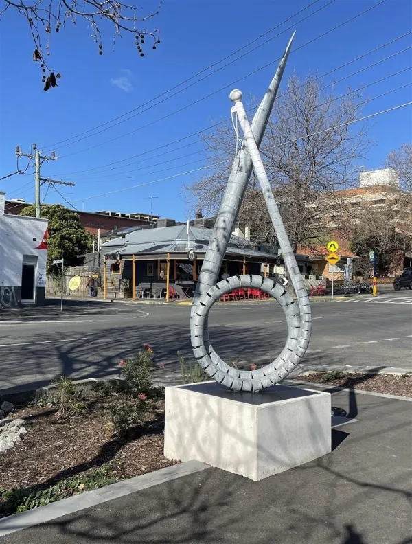 Furl 2022 by Robbie Rowlands. Public art sculpture metal pole on concrete slab