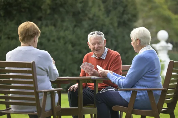 Seniors.jpg Group of senior friends playing cards at Geelong Botanic Gardens.