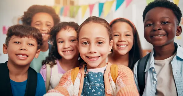 Children's Week Grants are now open for applications. Six children smiling in a photo