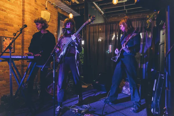 Live Music in Geelong Image of three band members playing a gig. One playing keyboard, one guitar and one bass.