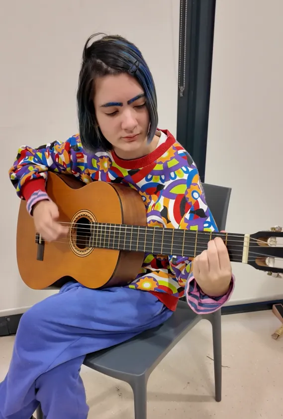 Musician Kitty Beach Young person playing the guitar
