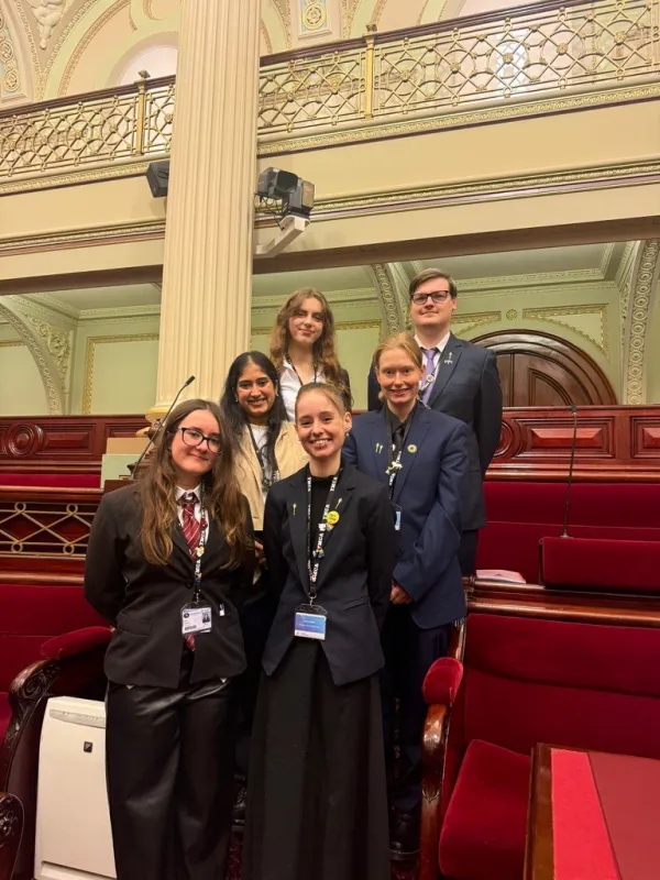 2026 Youth Parliament six young people standing in to columns of three dressed in their formal wear at Parliament