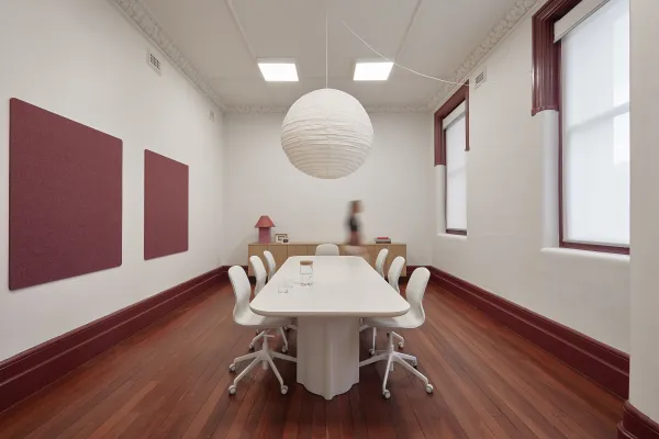 Design Commons Burgundy Room Burgundy coloured co maker space with large white table and chairs