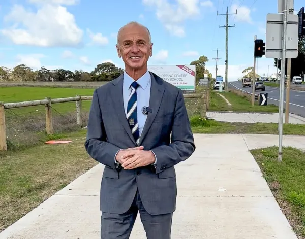 Mayor Stretch Kontelj OAM at intersection of Baanip Boulevard and Surf Coast Highway Mayor Stretch Kontelj OAM stands at intersection of Baanip Boulevard and Surf Coast Highway