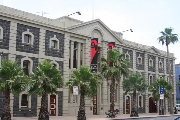 National Wool Museum Large heritage listed building with palm trees out front.