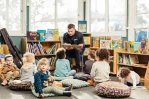 City of Greater Geelong Family Services A City of Greater Geelong family services employee reading a book to a group of children