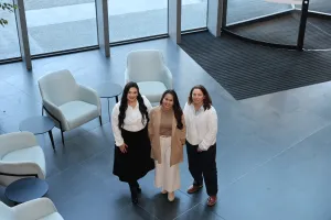 Scholarship recipients Natasha, Cecile and Kylie. Three women standing and smiling